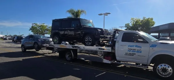 Fast Hook Towing flatbed towing a Jeep Wrangler — 4WD towing Inland Empire