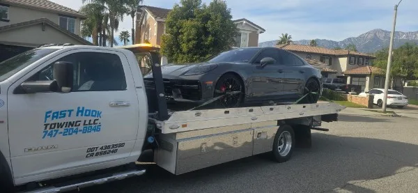 Fast Hook Towing flatbed towing a Porsche Taycan — luxury car towing