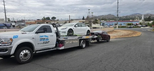 Fast Hook Towing flatbed towing a Tesla Model 3 — EV towing Inland Empire