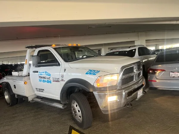 Fast Hook Towing flatbed tow truck in parking garage — front view