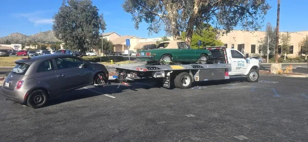Fast Hook Towing flatbed towing a vintage Ford Mustang convertible