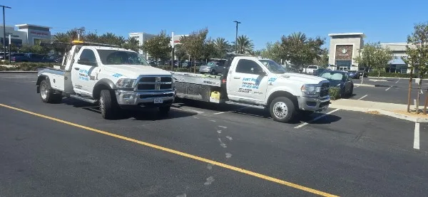 Fast Hook Towing fleet of flatbed tow trucks on a sunny day
