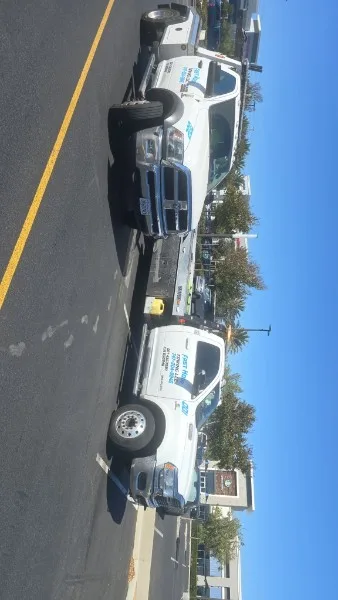 Fast Hook Towing fleet — two Ram flatbed tow trucks