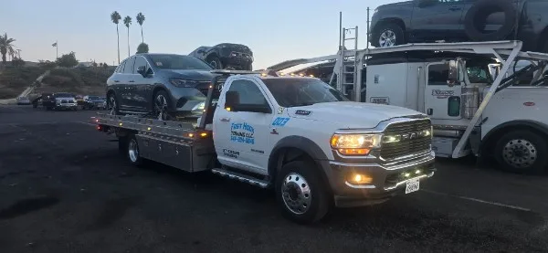 Fast Hook Towing Ram flatbed tow truck at dusk — Inland Empire