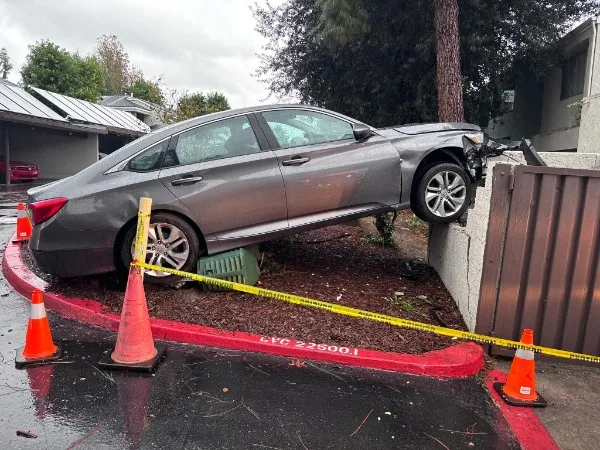 Honda Accord accident recovery — vehicle over curb collision scene